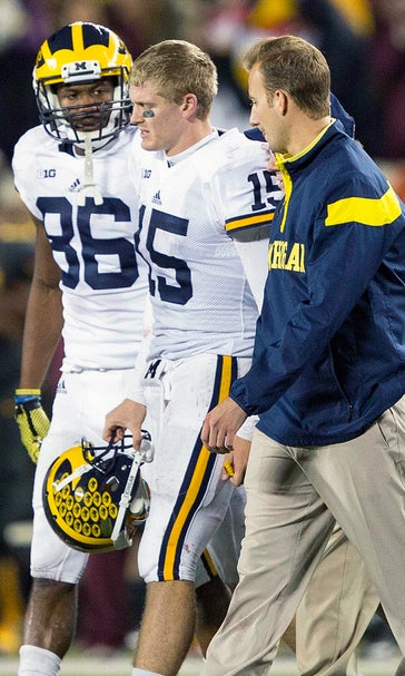 Michigan begins week with uncertainty about quarterbacks